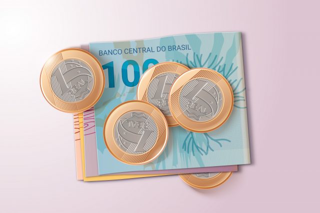 moedas de um real e notas de dinheiro representando o empréstimo sem garantia