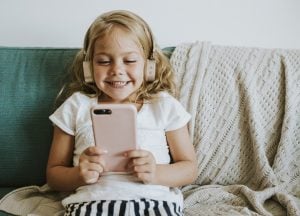 Little girl watching cartoons on her phone C6 Bank