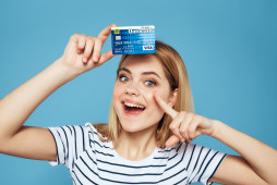 uma mulher segurando o Cartão de crédito Ourocard Pré-pago Recarregável