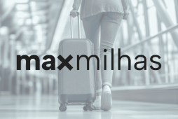 logo maxmilhas com pessoa puxando bagagem ao fundo para representar se MaxMilhas é confiável