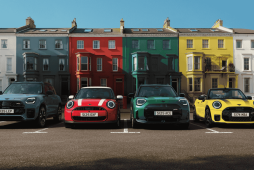 vários veículos na frente de casas coloridas para representar o Mini Cooper valor
